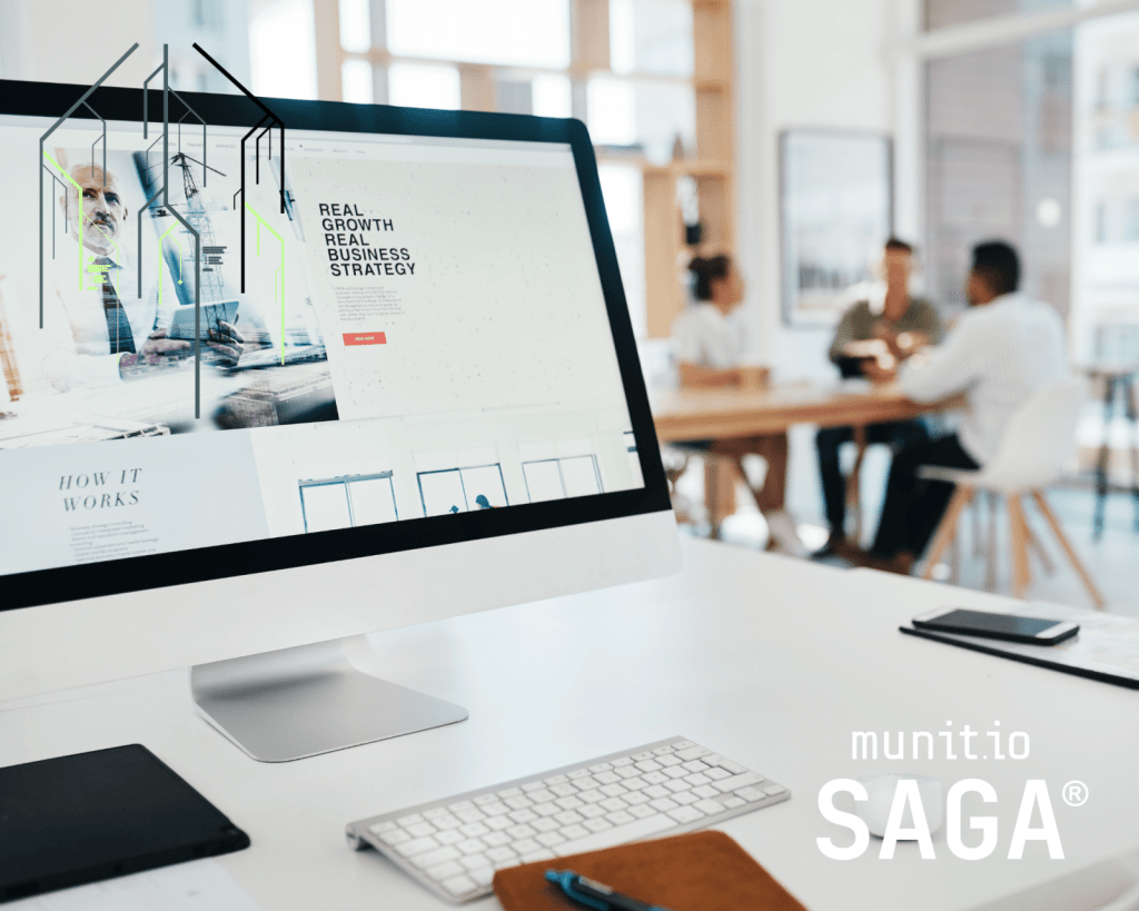 Office desk with a computer displaying a business strategy website, while a team meets in the background—reflecting digital risk monitoring in action.