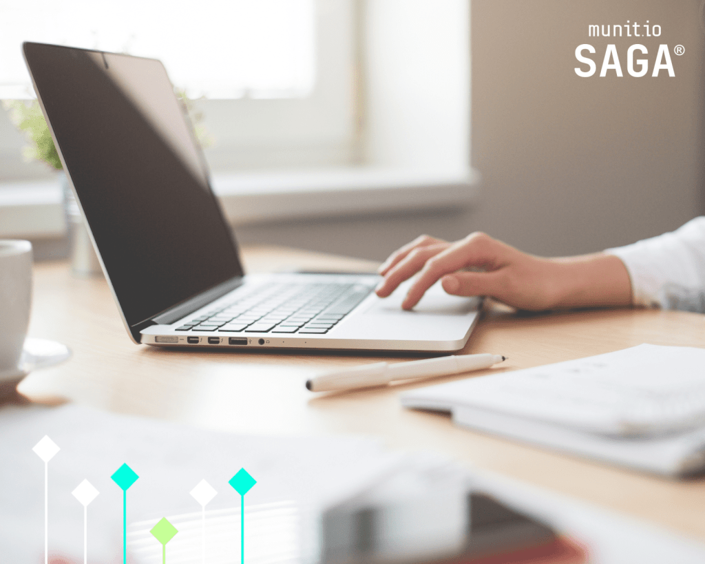 A person’s hand rests on a laptop in a bright office, symbolizing research or action on how to get a website taken down using professional tools.