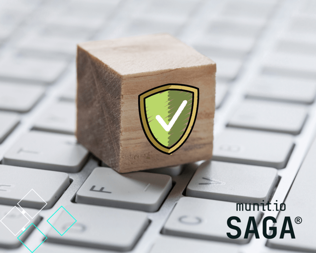 A wooden block with a green shield and checkmark rests on a computer keyboard, symbolizing protection and addressing what is a cyber threat.