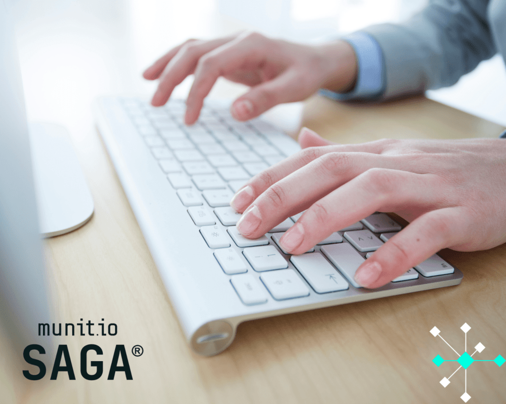 Close-up of hands typing on a white keyboard, emphasizing the digital vigilance and data management crucial for protecting your brand from online threats.