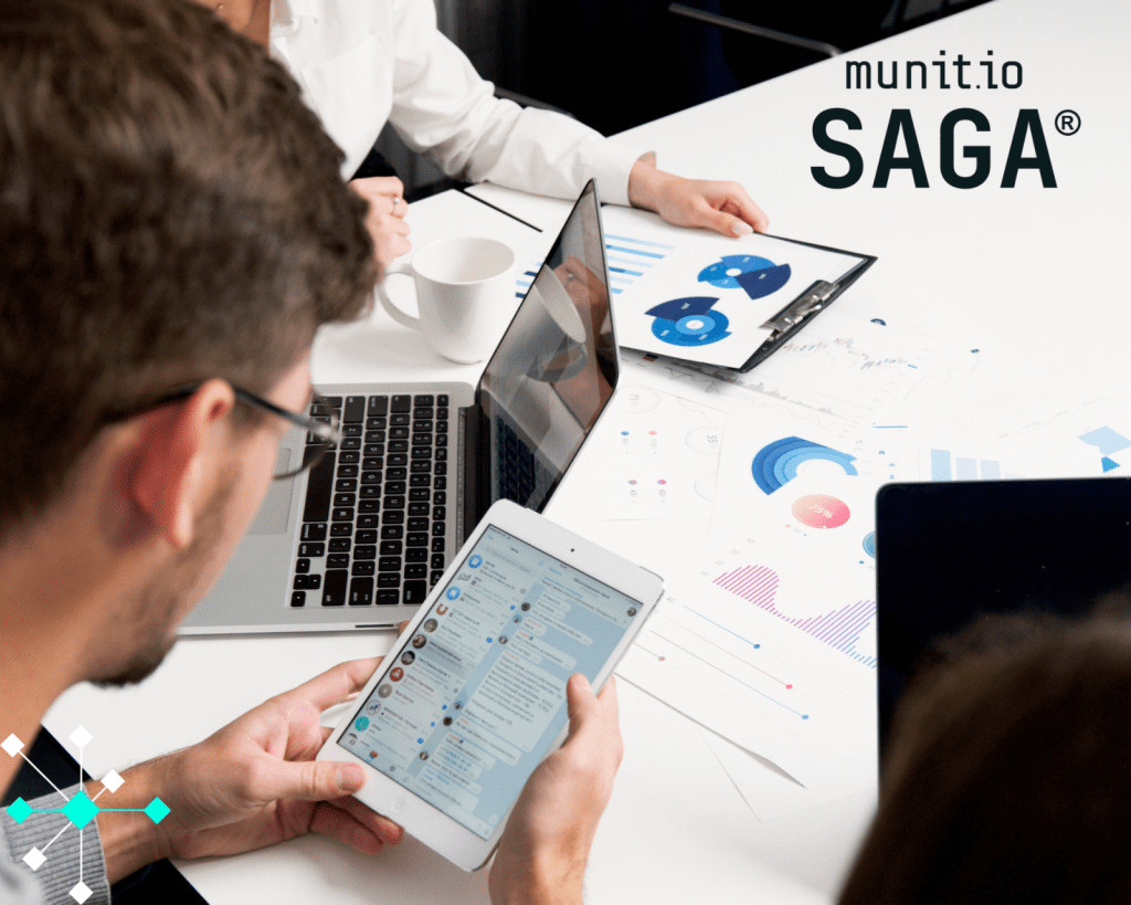 Business professionals analyzing digital dashboards, chat logs, and performance data on tablets and laptops—illustrating how executive monitoring solutions track digital exposure and executive risk indicators in real time.
