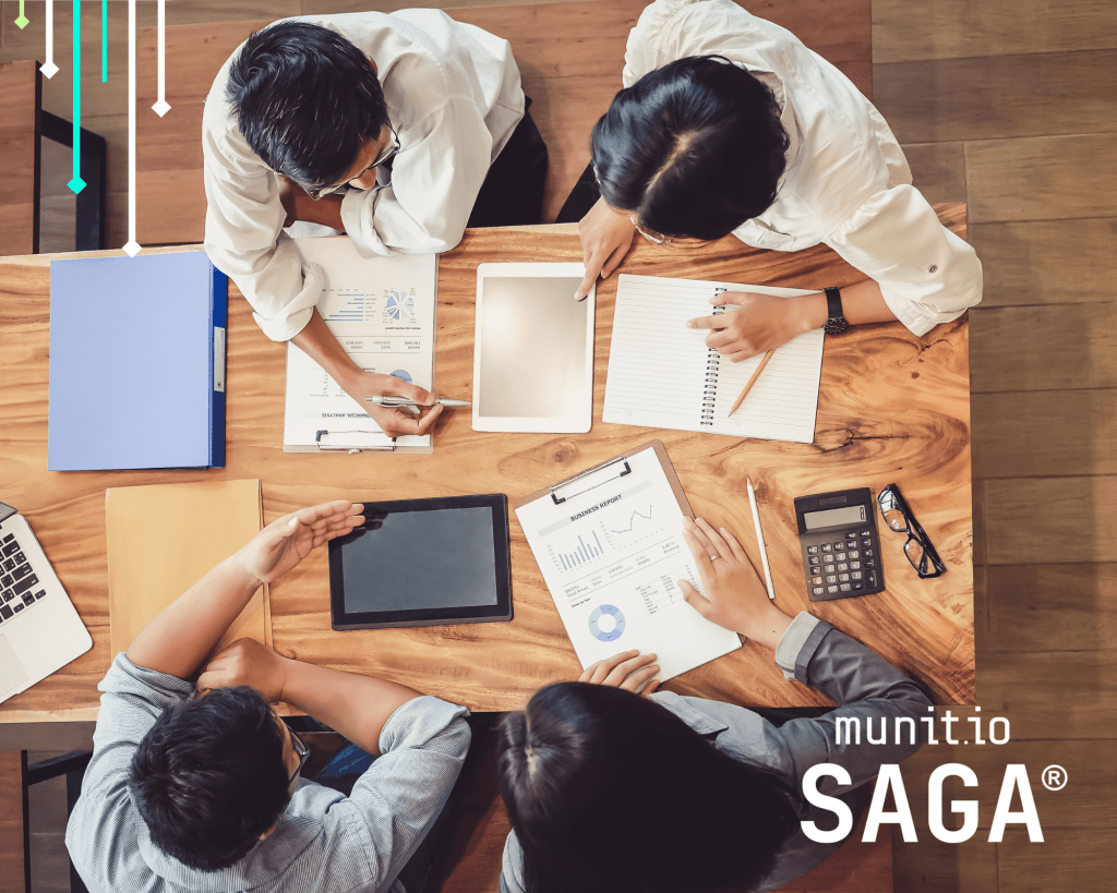 Business team analyzing charts, reports, and digital devices during a meeting, highlighting the importance of what is an insider threat cyber awareness for protecting sensitive corporate data.