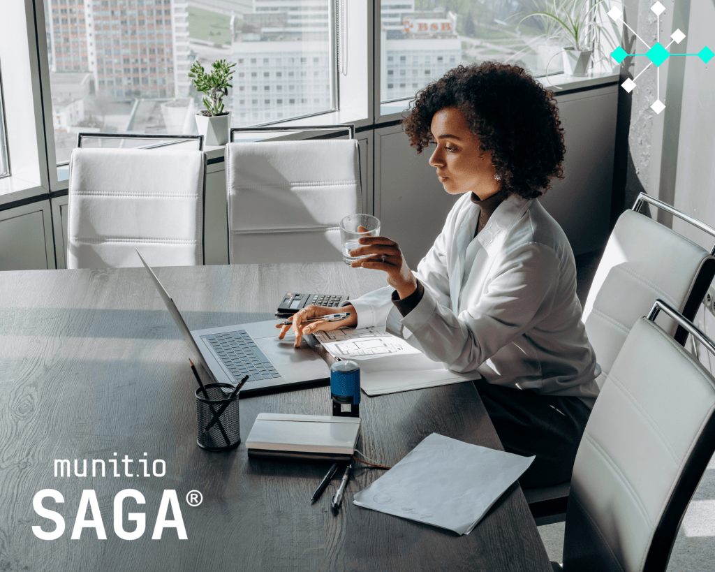 A business professional analyzing reports and data on a laptop in a high-rise office, reflecting how Supply Chain Intelligence supports strategic risk assessment and vendor decision-making.