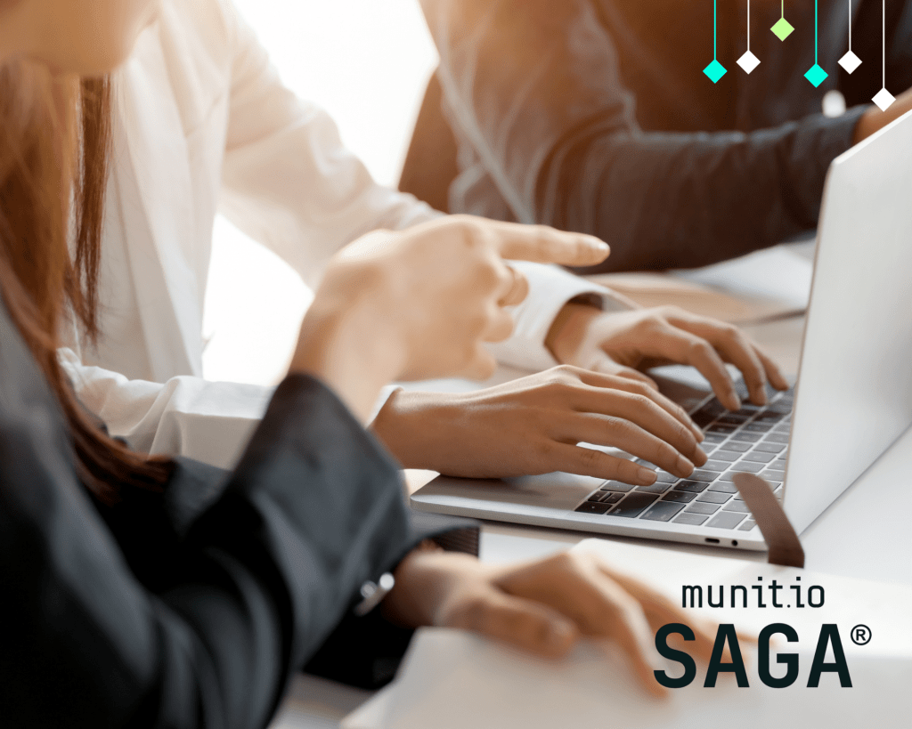 Business professionals collaborating on a laptop, highlighting how external attack surface monitoring provides visibility into exposed assets and cybersecurity risks.