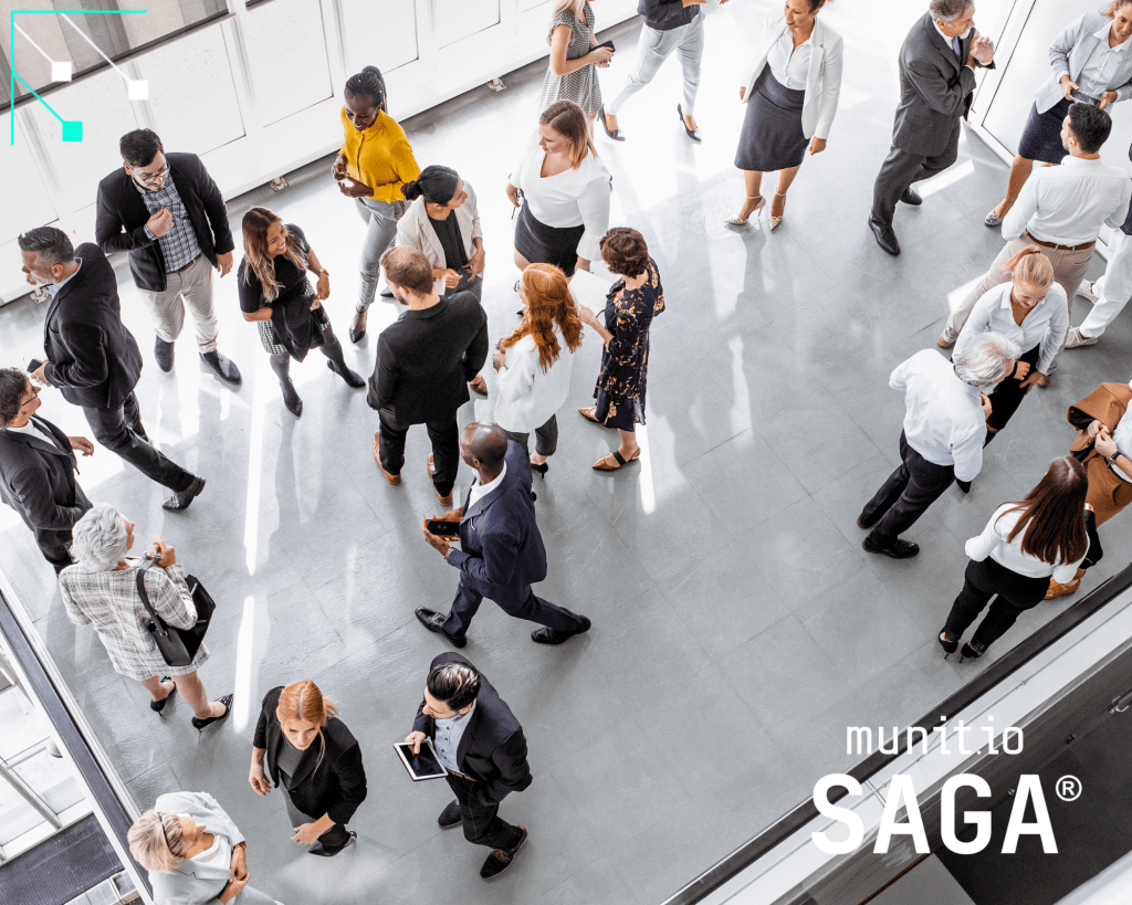 Business professionals gathered in a corporate lobby during a networking event, illustrating the need for stolen password detection for businesses to protect employee accounts across large workforces.