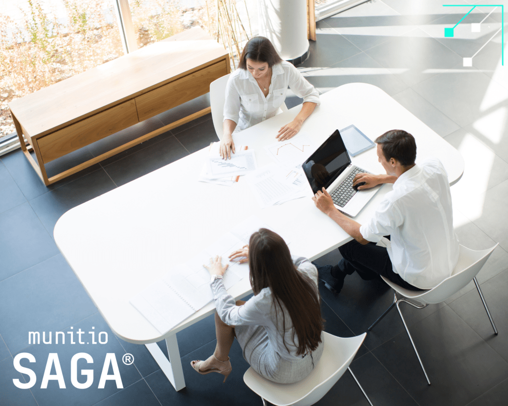 Three professionals collaborating at a modern office table with laptops and documents, highlighting how an automatic stealer logs detection tool supports informed decision-making and data protection strategies.