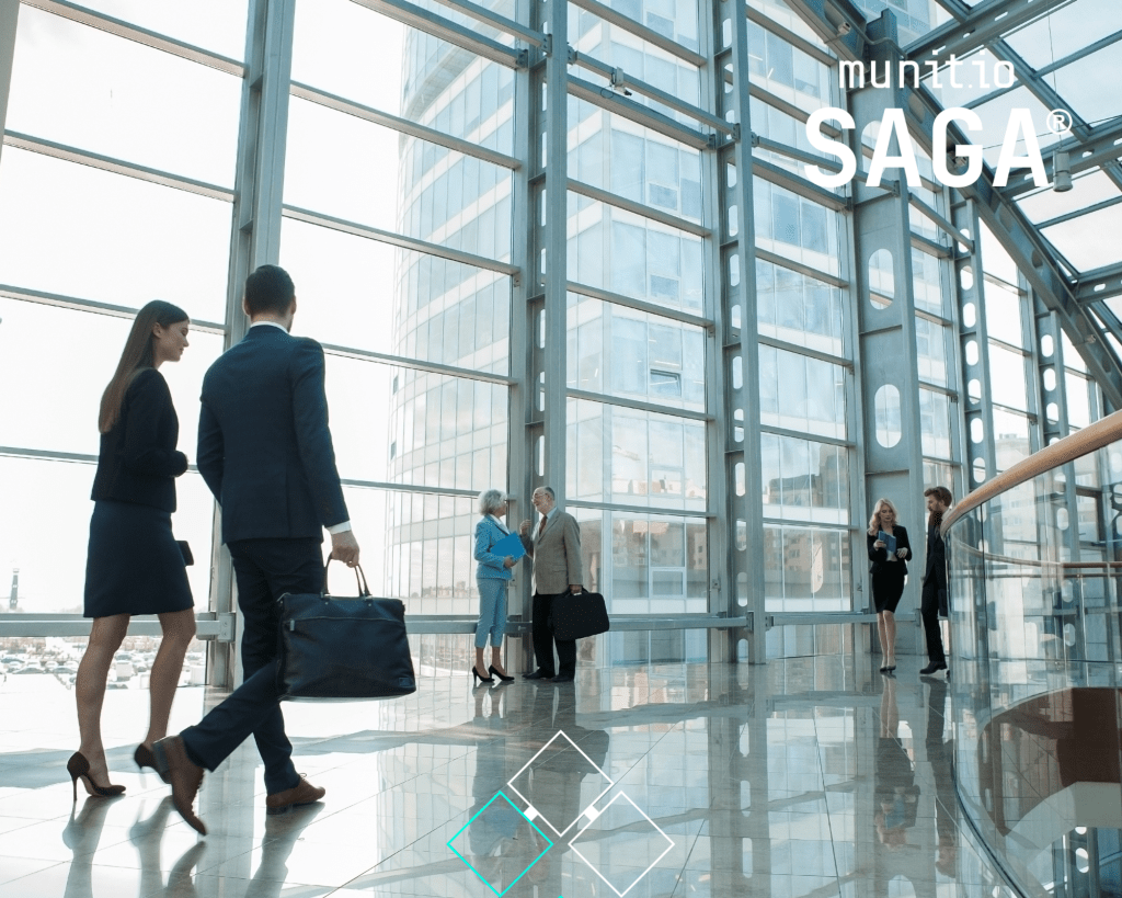 Professionals walking through a modern glass office building, representing corporate collaboration and awareness — highlighting what are external digital risks in maintaining secure digital and physical environments.