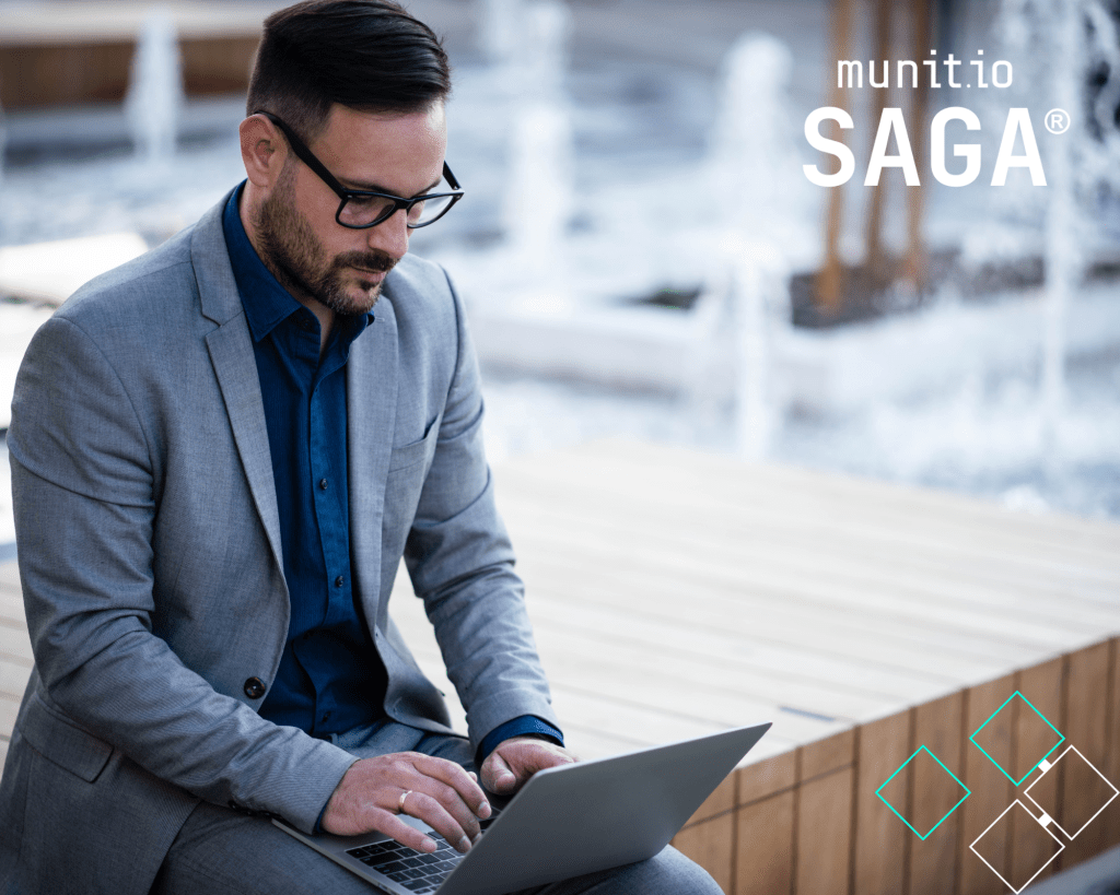 A professional man in a suit works on a laptop outdoors, illustrating the growing need to understand What is ransomware-as-a-service and how cybercriminals exploit digital access points to target organisations.