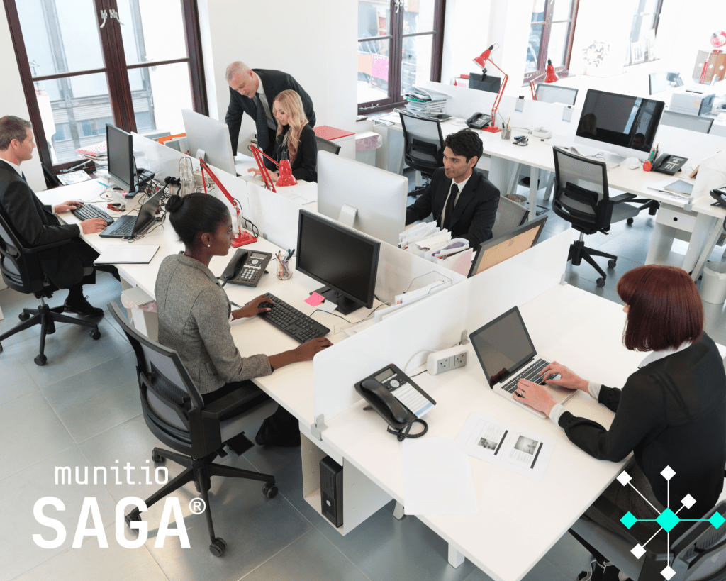 Teams working at office desks with computers, reflecting the need for businesses to understand how dark web marketplaces work to protect sensitive data and strengthen cyber resilience.