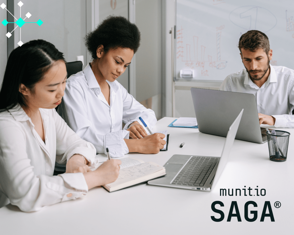 Three cybersecurity professionals working together at a desk with laptops and notes, illustrating what is phishing domain monitoring through collaborative analysis of suspicious domains and online threats.