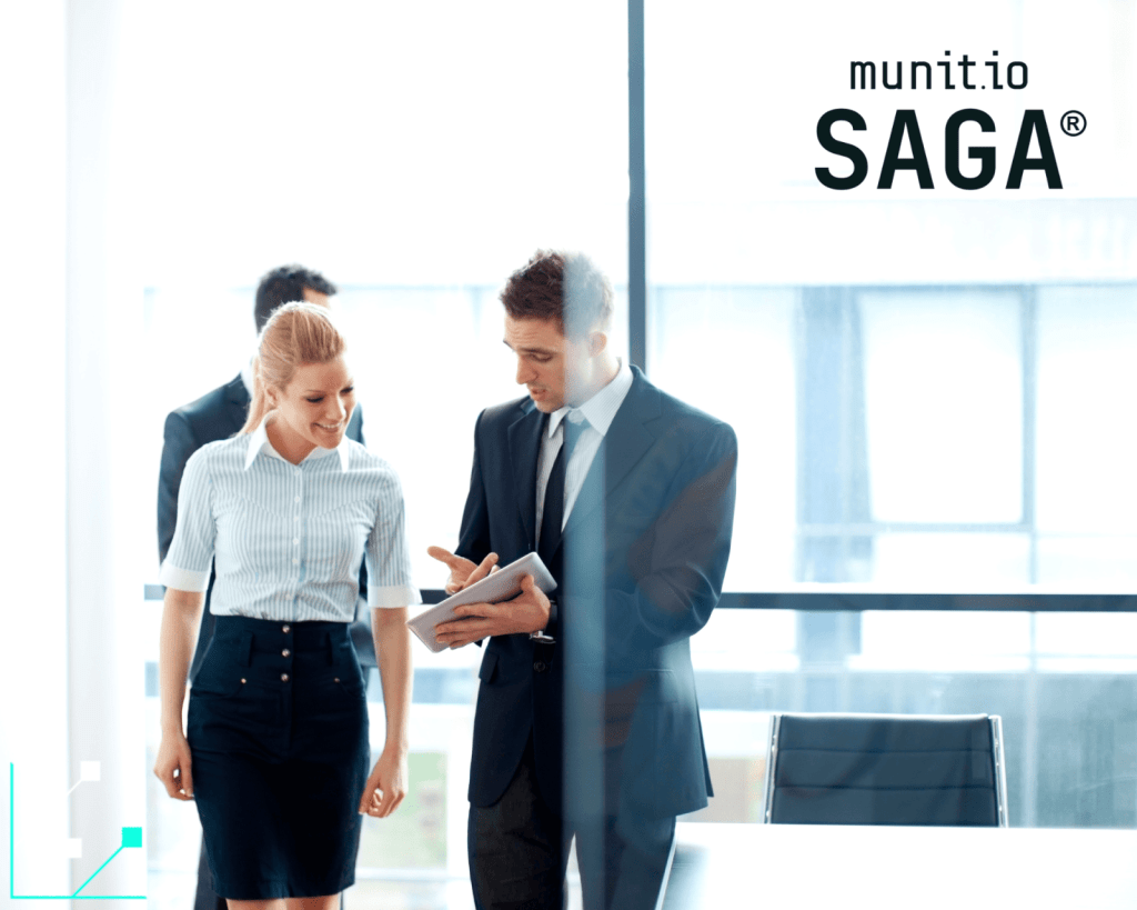 Two business professionals reviewing information on a tablet in a modern office setting, reflecting identity verification and mobile security concerns central to what is SIM swapping.