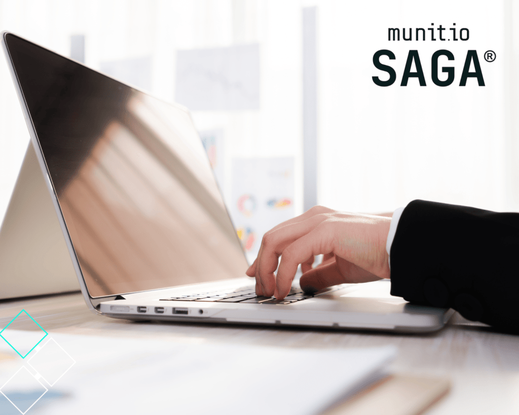 A person typing on a laptop in a bright office setting, highlighting the importance of understanding what is doxxing and how exposed digital activities can lead to the unauthorized disclosure of personal information.