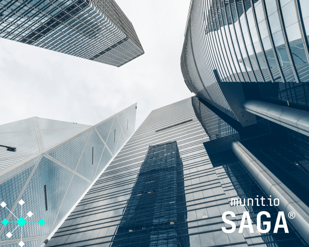 Modern glass skyscrapers viewed from below, symbolizing large-scale digital infrastructure and corporate environments where mobile identity risks like what is SIM swapping can have serious security implications.