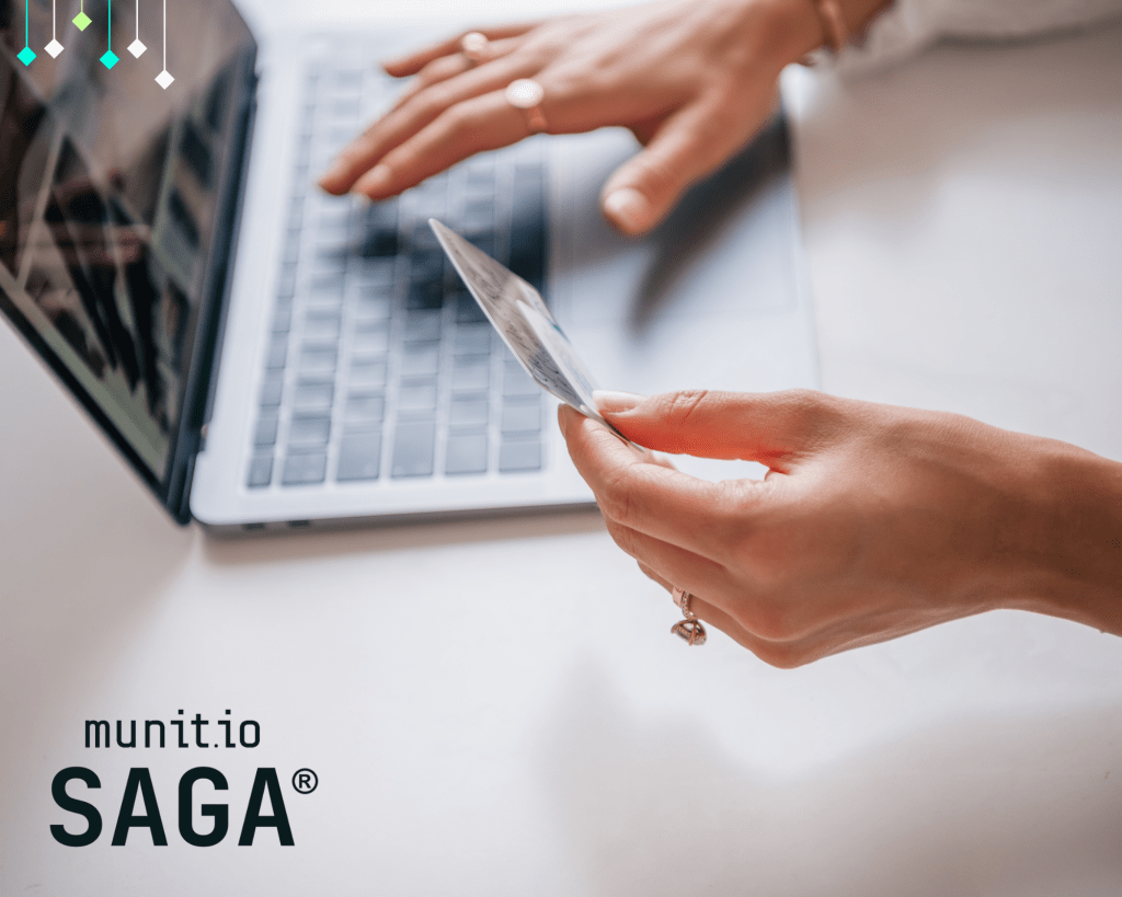Hands holding a credit card while typing on a laptop keyboard, illustrating risks associated with credit card information leaked during online transactions and digital data exposure.