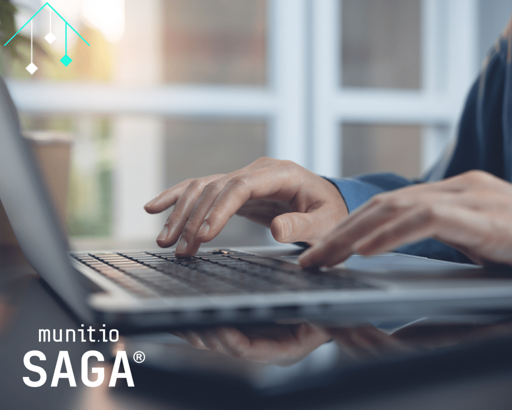 Hands typing on a laptop in a professional workspace, representing Brand abuse monitoring on social media through continuous digital surveillance and online threat detection.