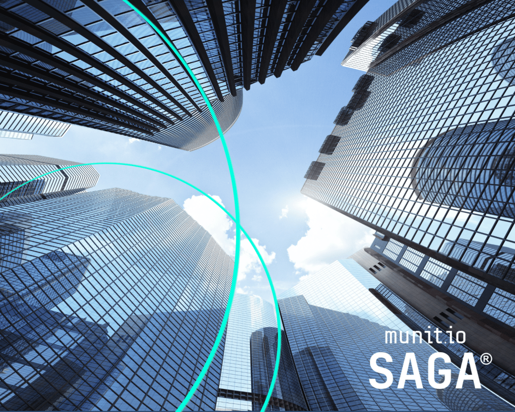 Glass skyscrapers viewed from below against a blue sky, representing corporate environments where organizations ask, How do you detect stolen employee credentials? to protect sensitive data and digital infrastructure.