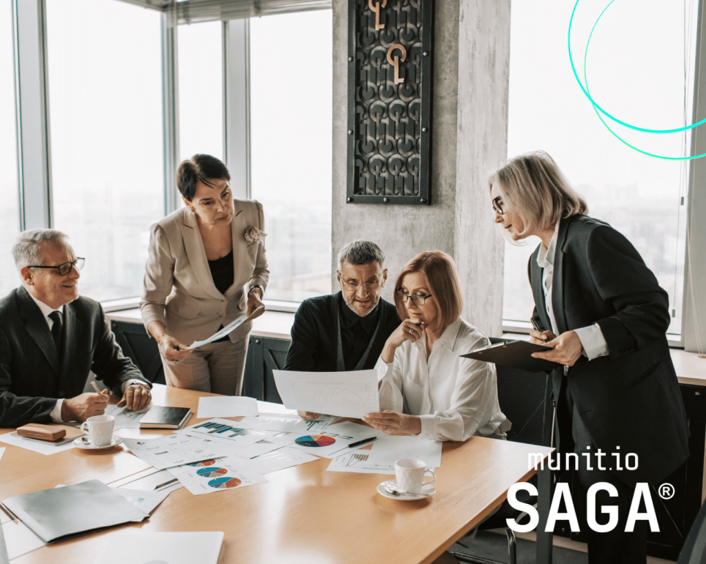 Business professionals reviewing reports and charts during a strategy meeting, demonstrating How do you build a cyber threat monitoring strategy? through collaborative risk assessment, data analysis, and proactive cybersecurity planning.
